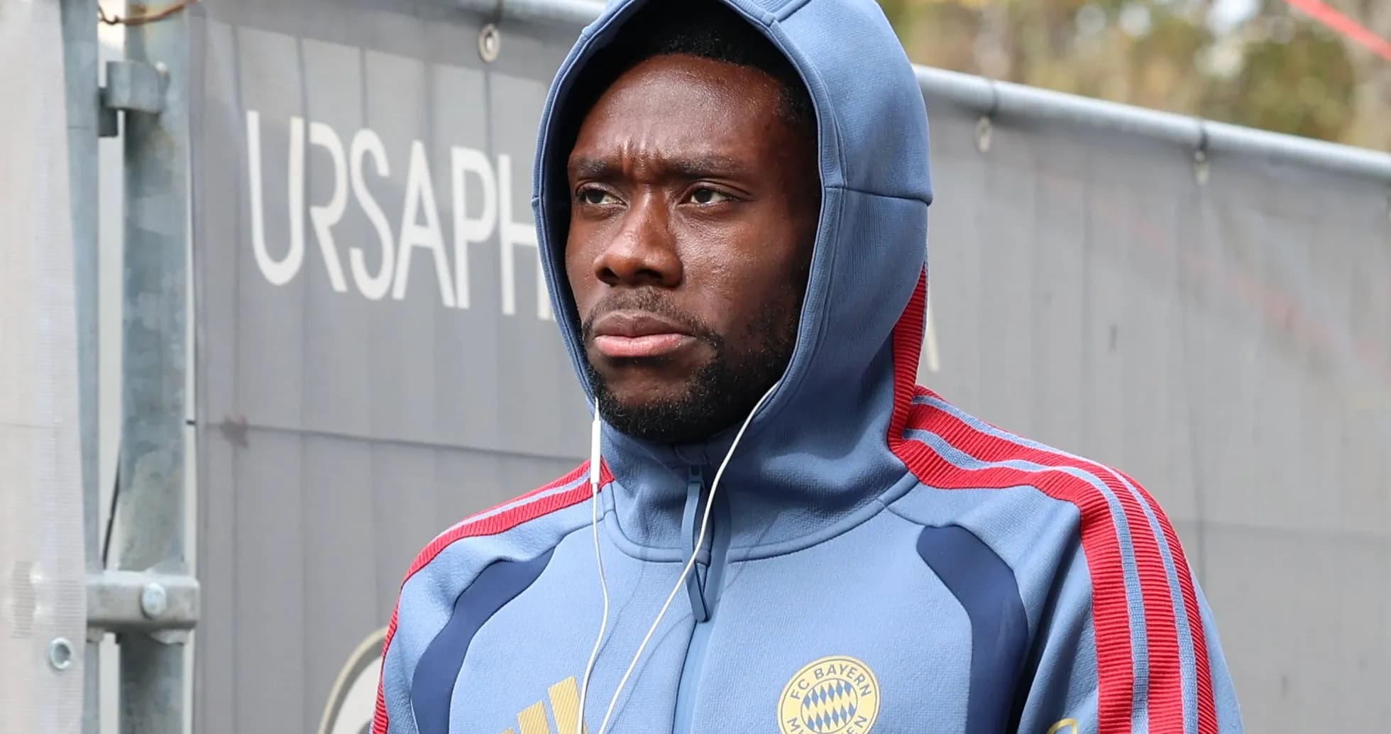 Player wearing Bayern Munich hoodie walking outdoors