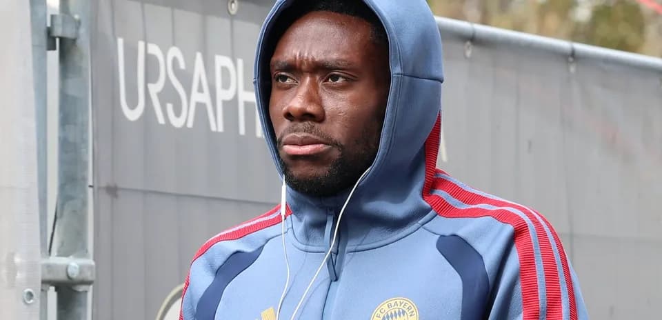 Player wearing Bayern Munich hoodie walking outdoors