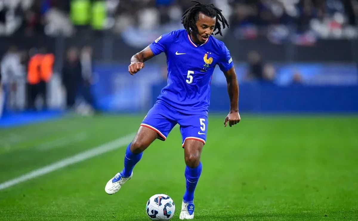 Player in blue jersey dribbling soccer ball on field