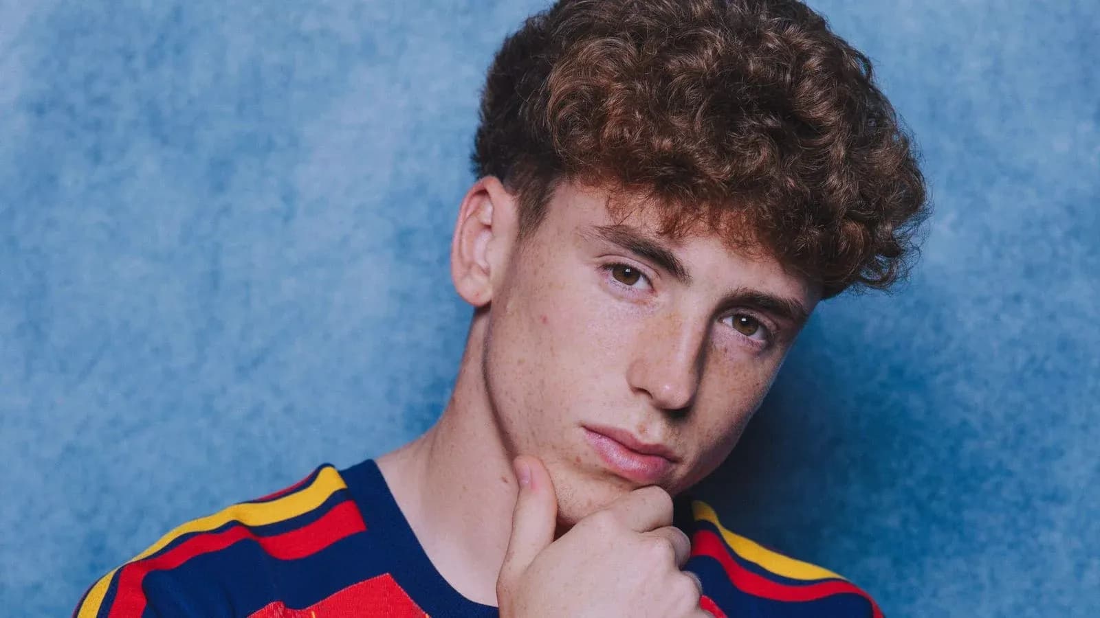 Young man posing with hand on chin
