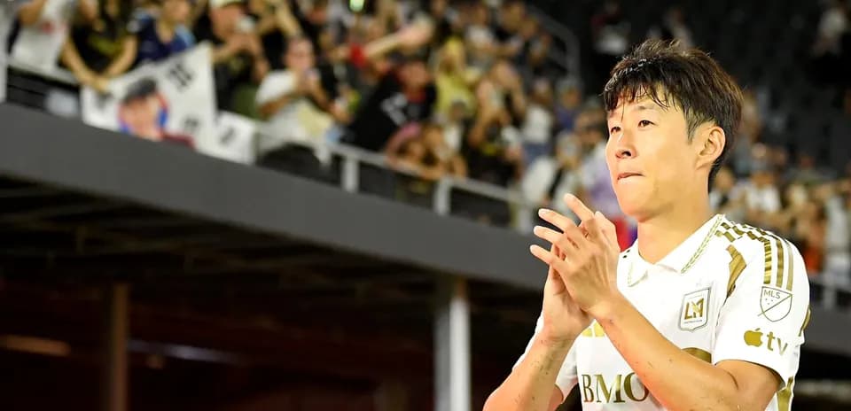 Player applauding fans after match in stadium