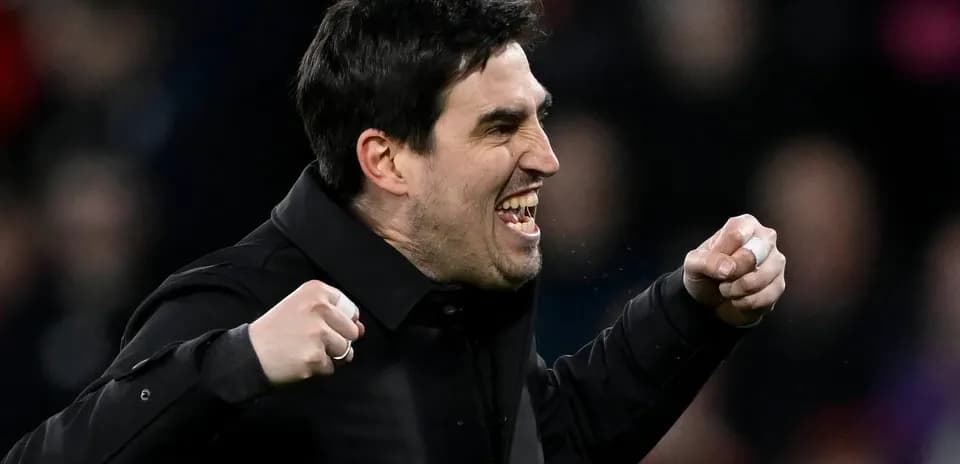 Coach celebrating with clenched fists during match