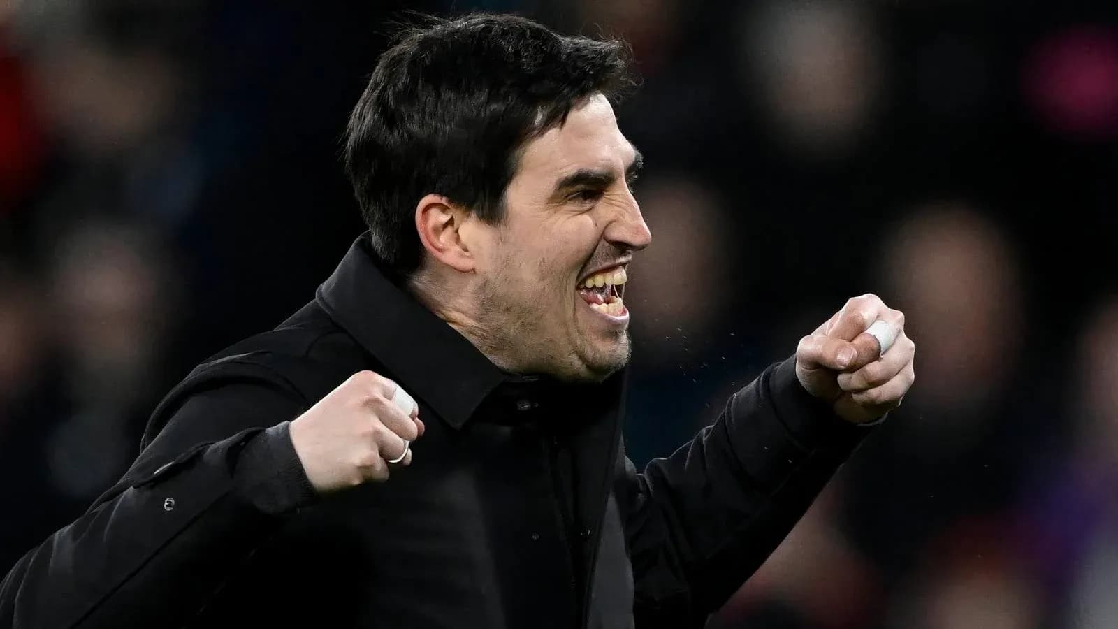 Coach celebrating with clenched fists during match