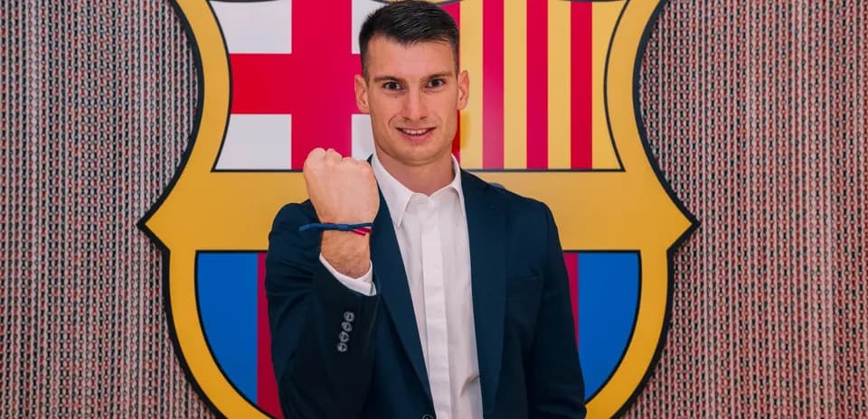 Player posing with Barcelona crest in background