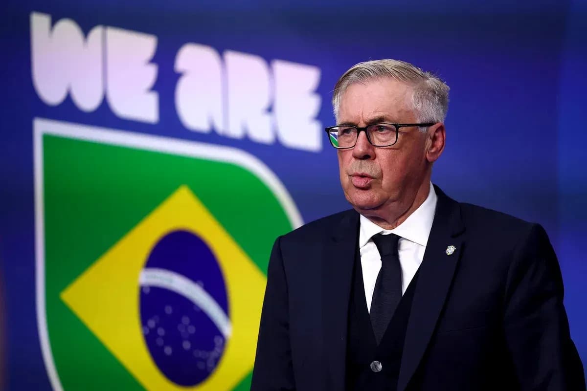 Football manager speaking in front of Brazil flag