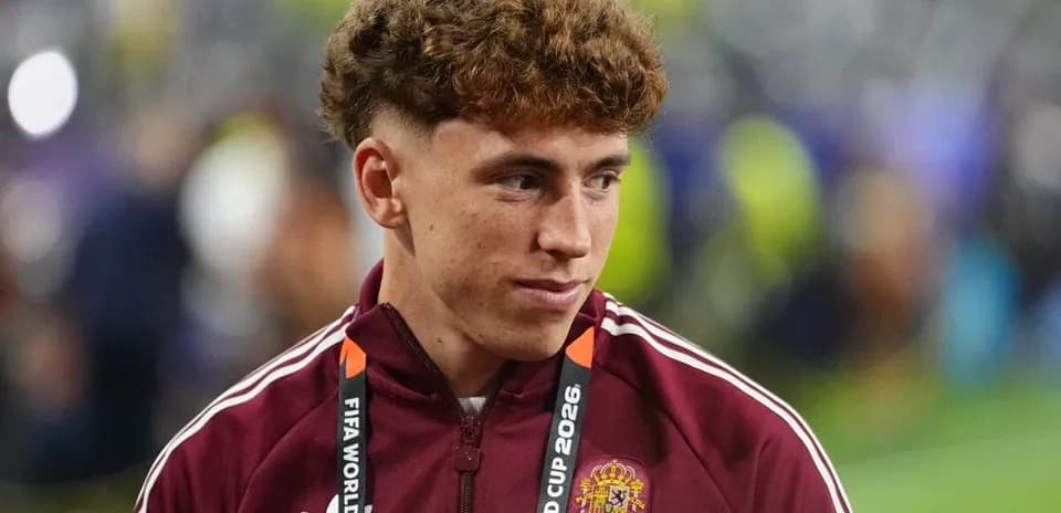 Player wearing maroon jacket with FIFA World Cup 2026 lanyard
