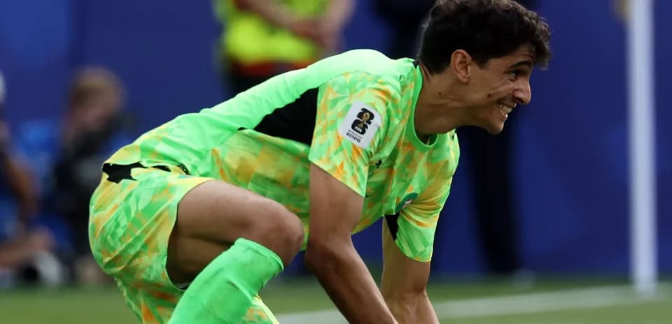 Goalkeeper in bright kit preparing for play