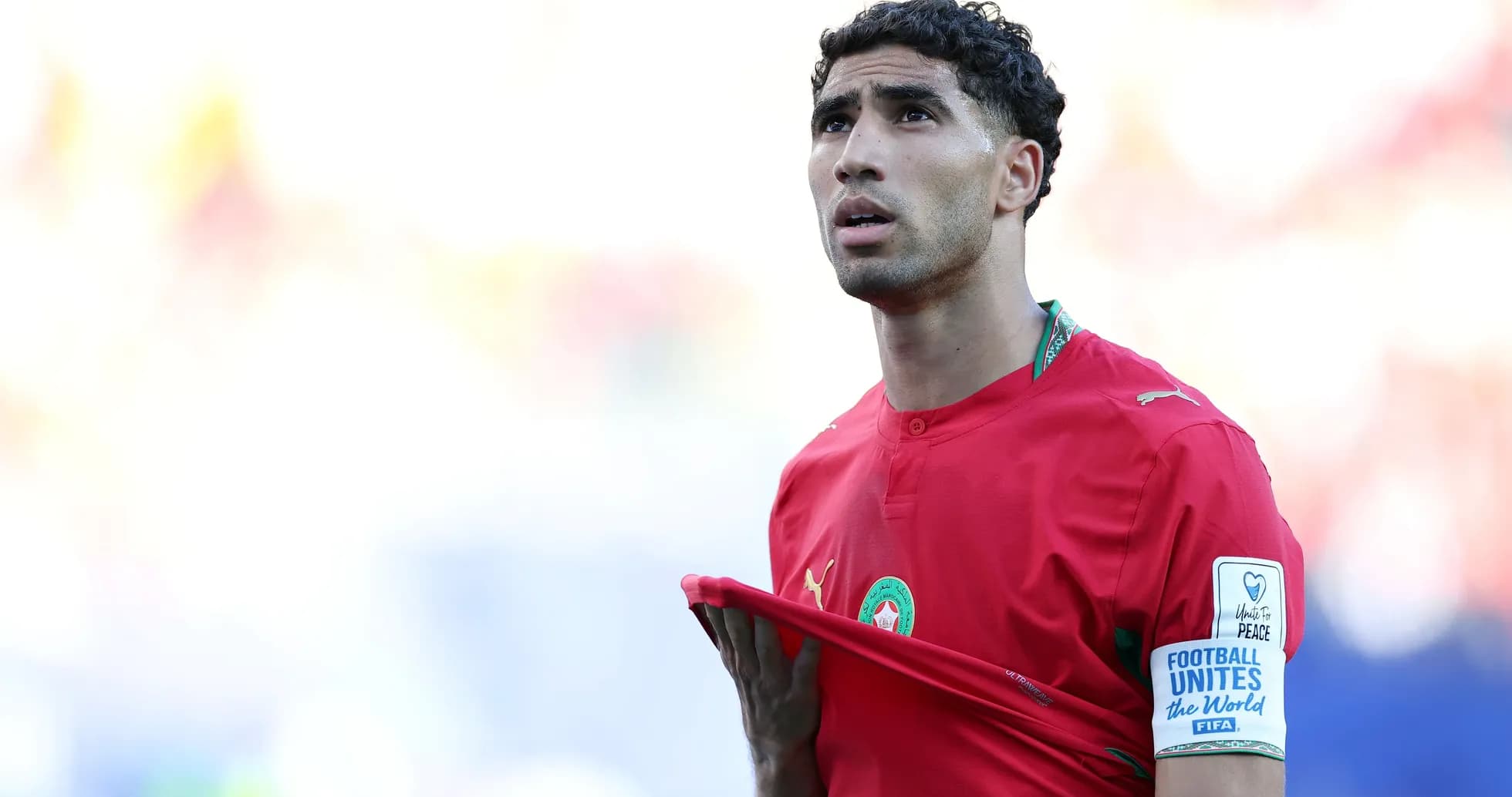 Player in red jersey looking upwards during match