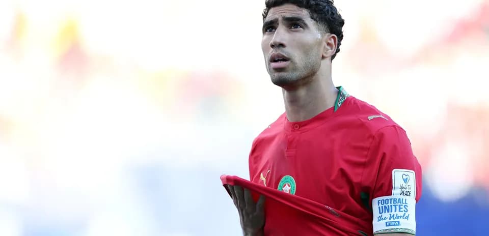 Player in red jersey looking upwards during match