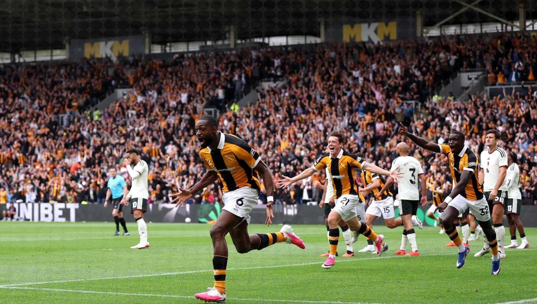 Player celebrating goal with teammates during match