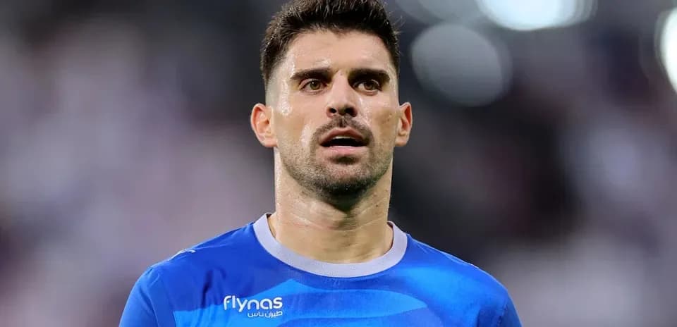 Football player in blue kit during match