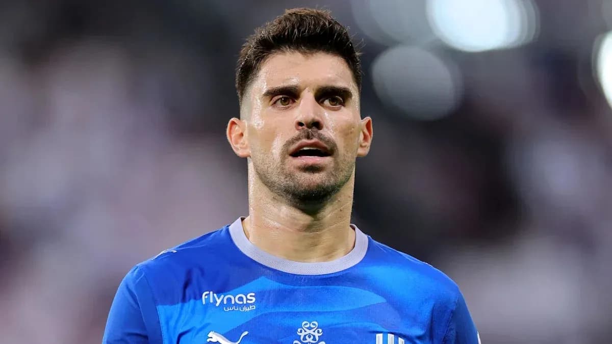Football player in blue kit during match