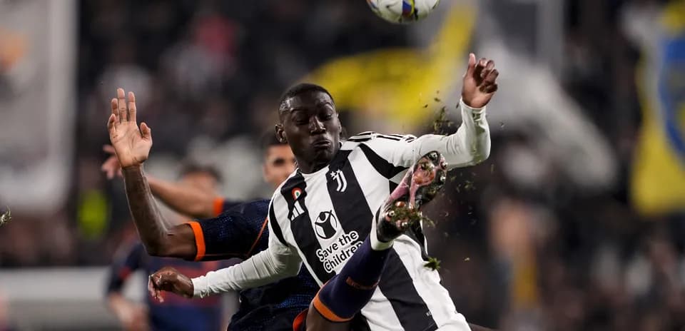 Juventus player challenging opponent during match