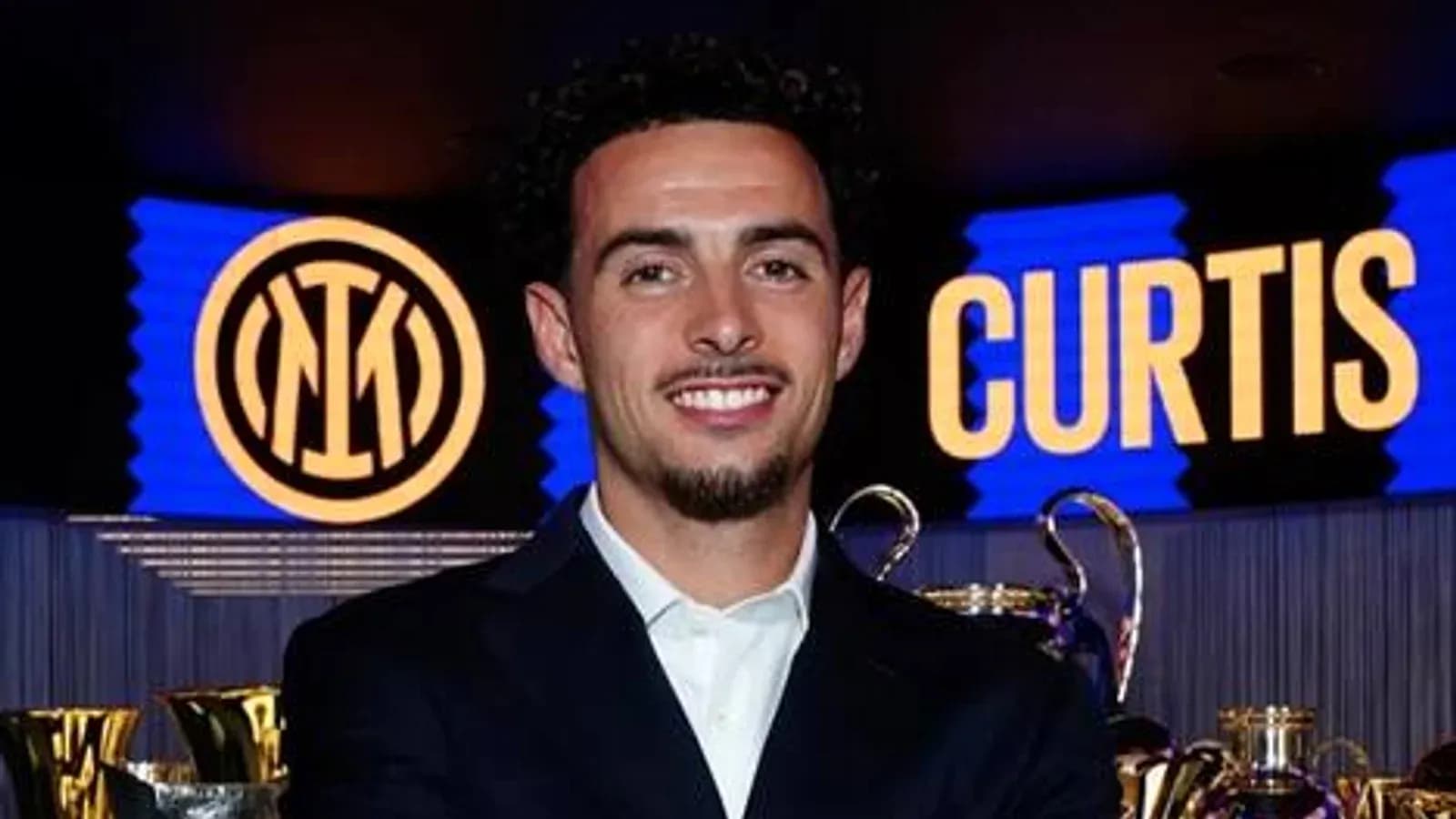 Player posing with trophies and Inter Milan logo
