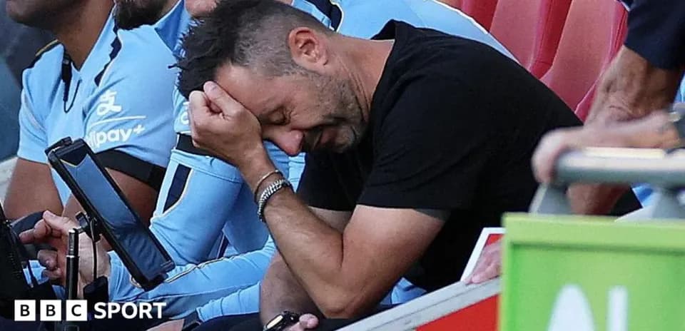 Coach with head in hand on team bench
