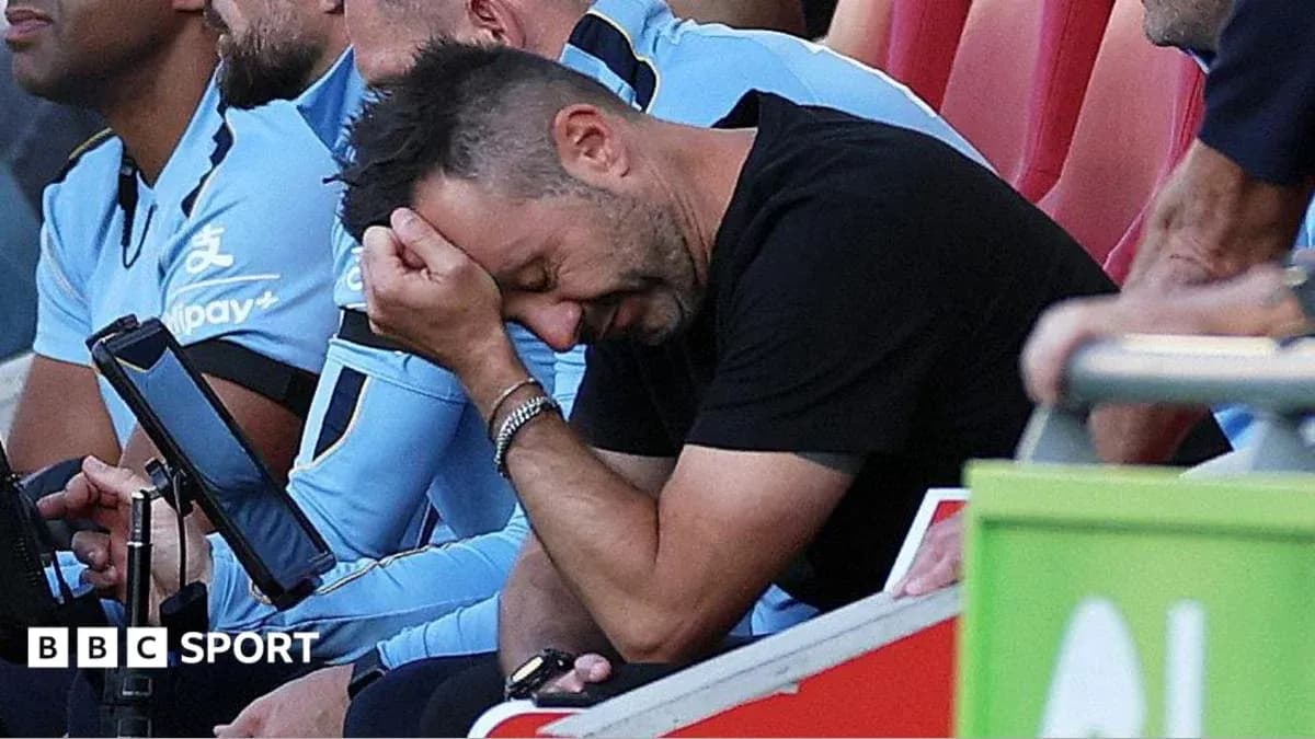 Coach with head in hand on team bench