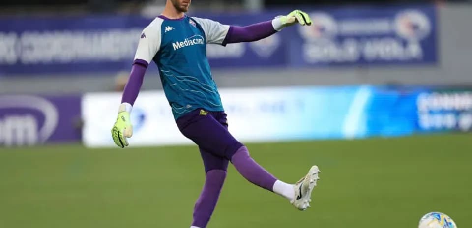 Goalkeeper practicing a kick during warm-up session