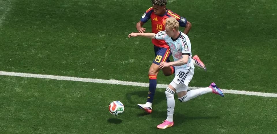 Two players battling for the ball on field