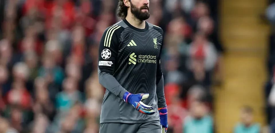 Goalkeeper in Liverpool kit walking on pitch