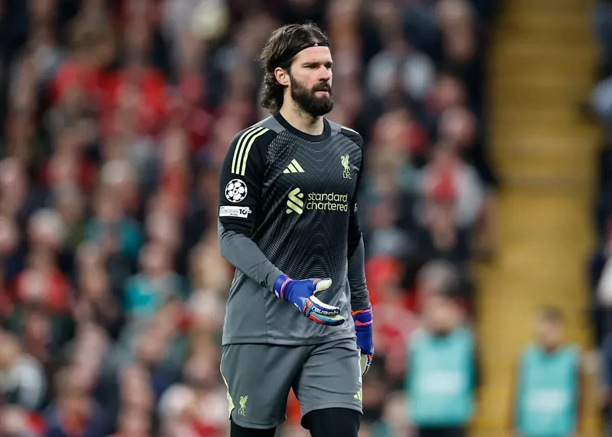 Goalkeeper in Liverpool kit walking on pitch