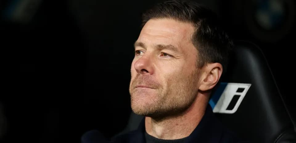 Coach sitting in dugout during match