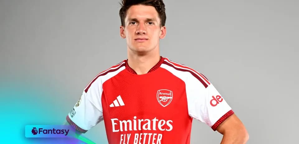 Player posing in Arsenal jersey against gray background