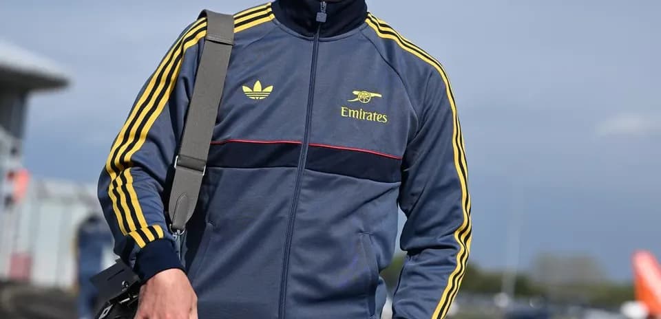 Athlete in tracksuit walking with a bag