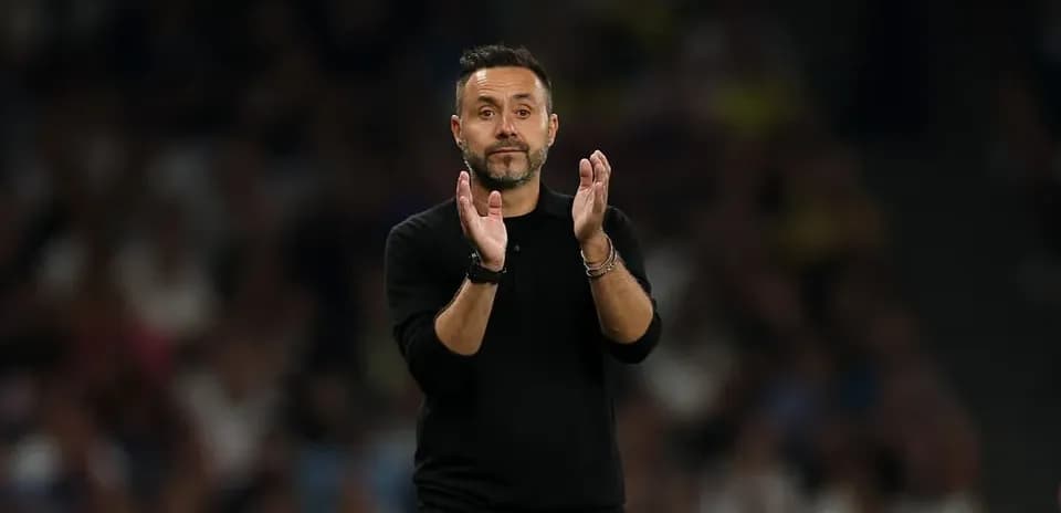 Coach applauding during a football match