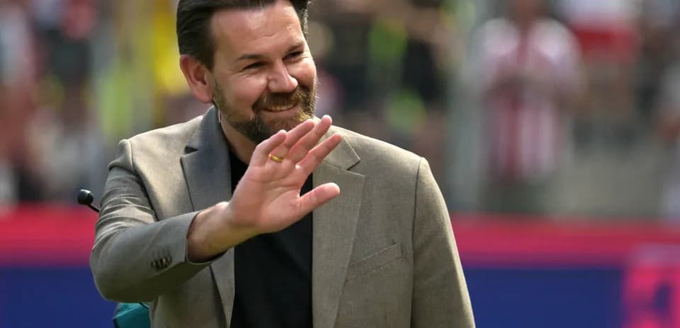 Man waving during a sports event on the field