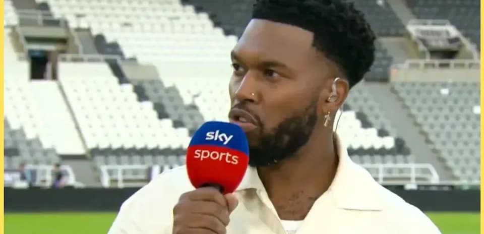 Presenter speaking into microphone at stadium