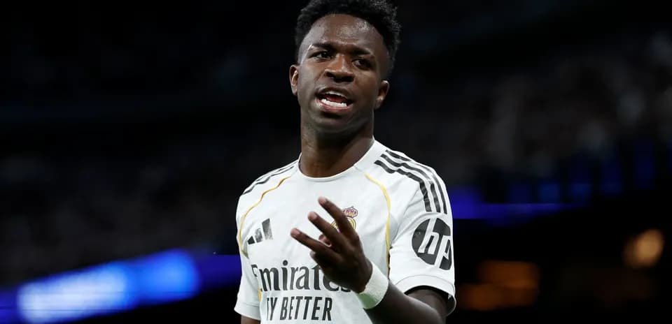 Player gesturing during a match wearing white jersey