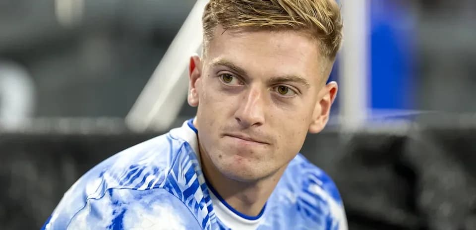 Player in blue jersey sitting on the bench