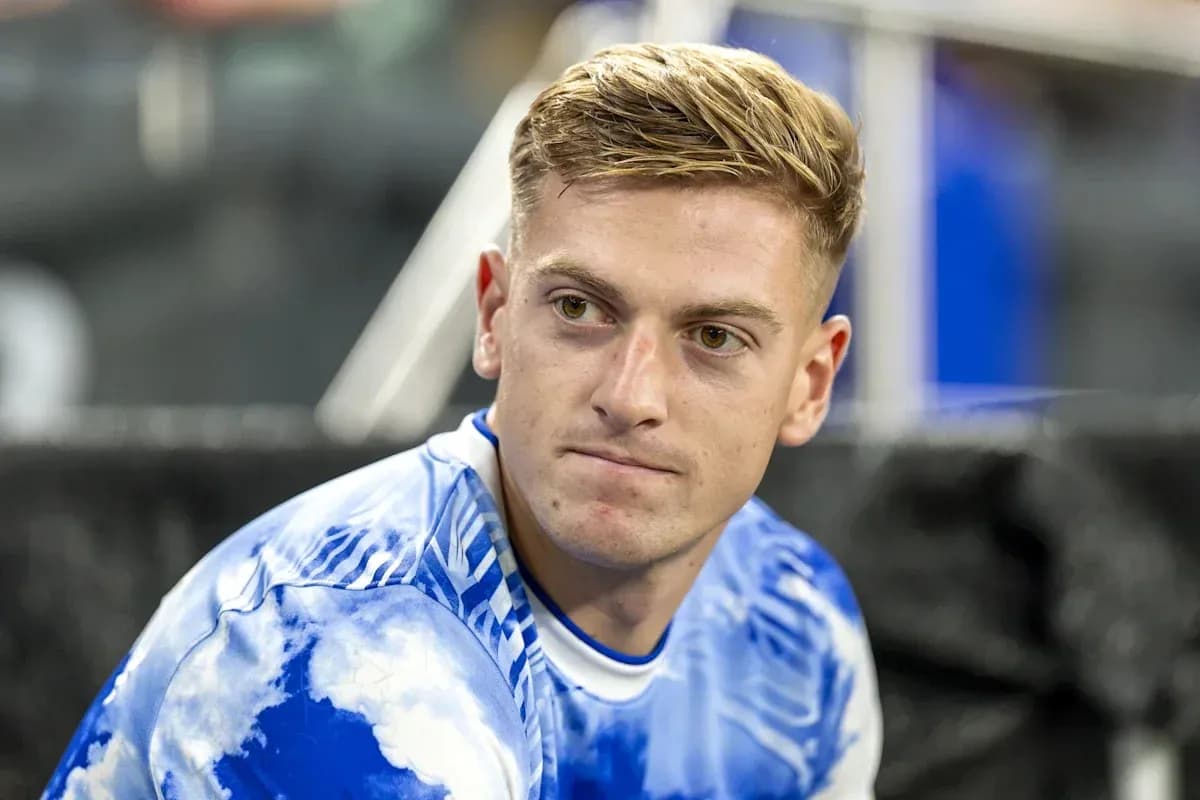 Player in blue jersey sitting on the bench