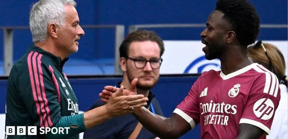 Manager and player shaking hands during match