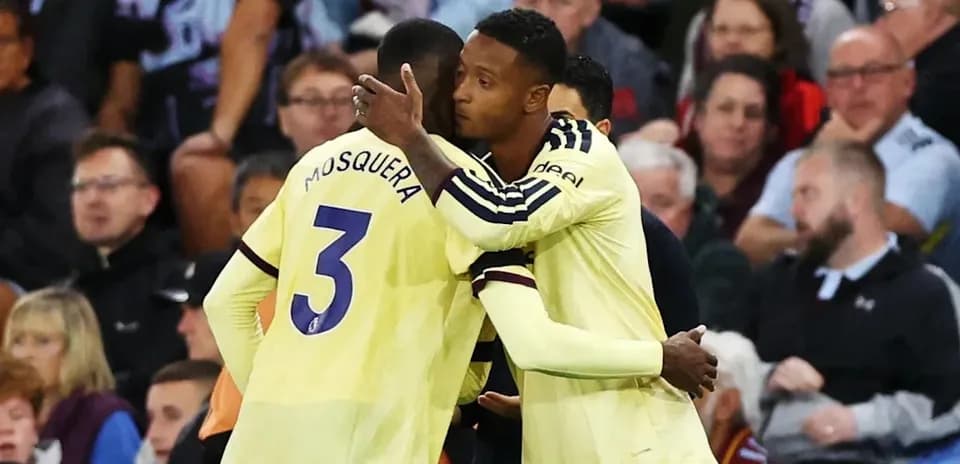 Players embracing on the sidelines during match