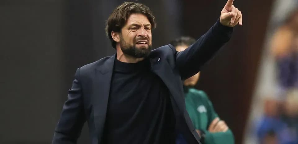 Coach gesturing during a match from the sidelines
