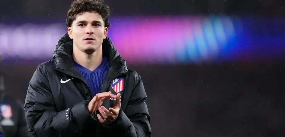Player applauding while wearing an Atletico Madrid jacket