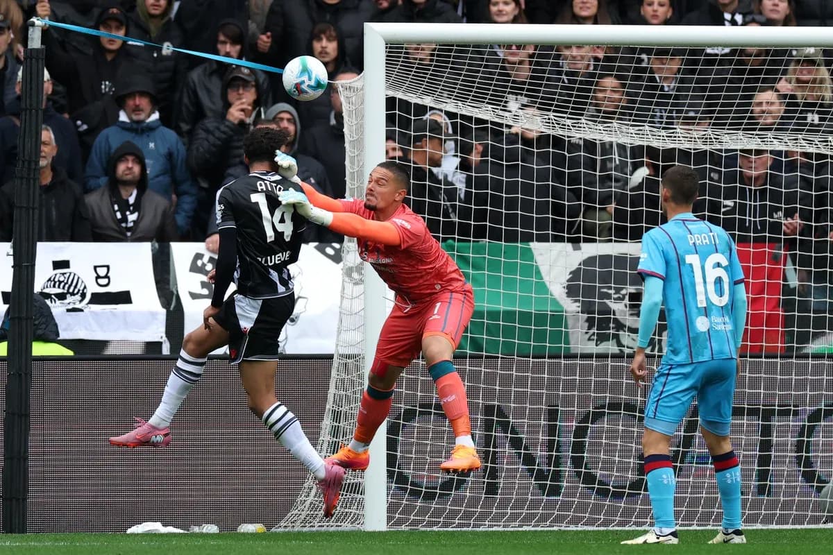 Goalkeeper and defender contesting for the ball