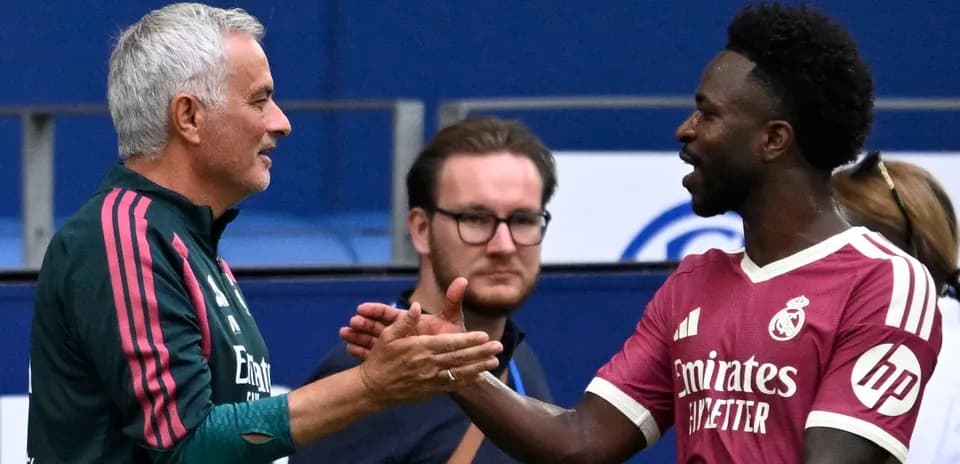 Manager and player shaking hands on the pitch