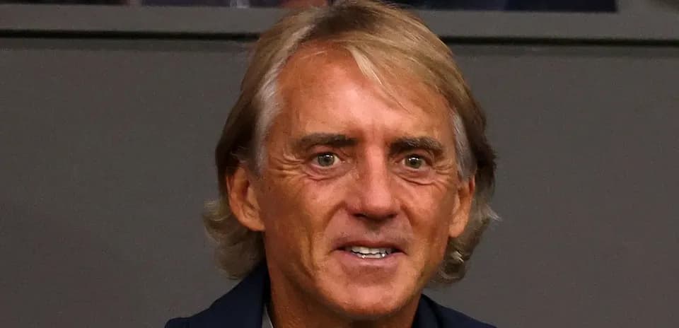 Man with blonde hair smiling at event