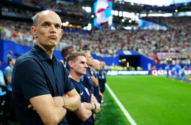 Coach observing match from the sideline with staff