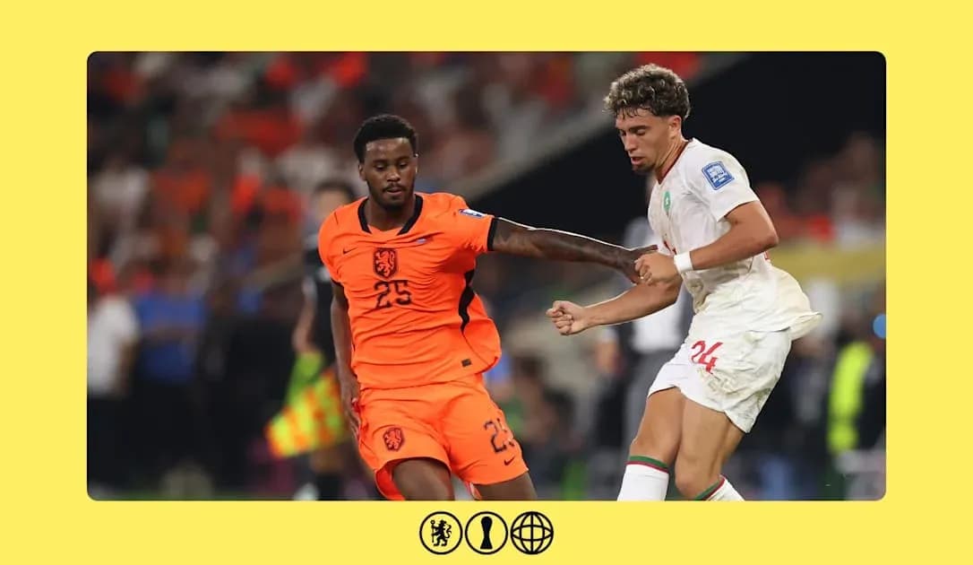 Player in orange and player in white battling for the ball