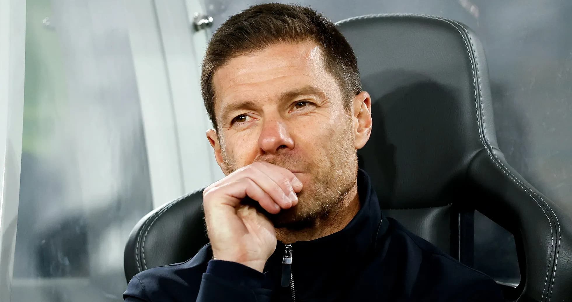 Coach sitting on bench during match