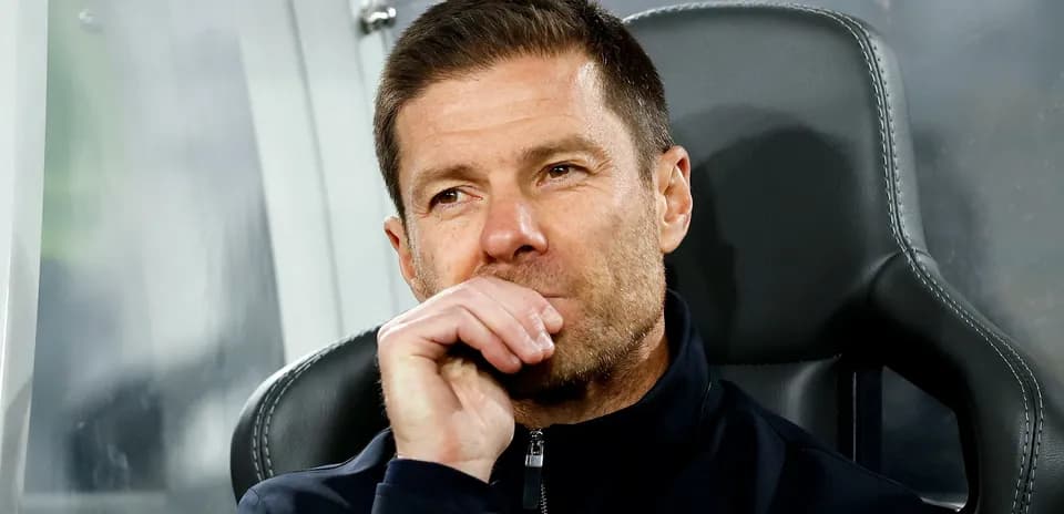 Coach sitting on bench during match