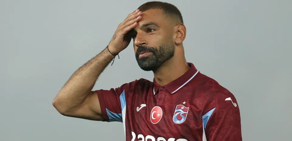 Player posing in new team jersey at event