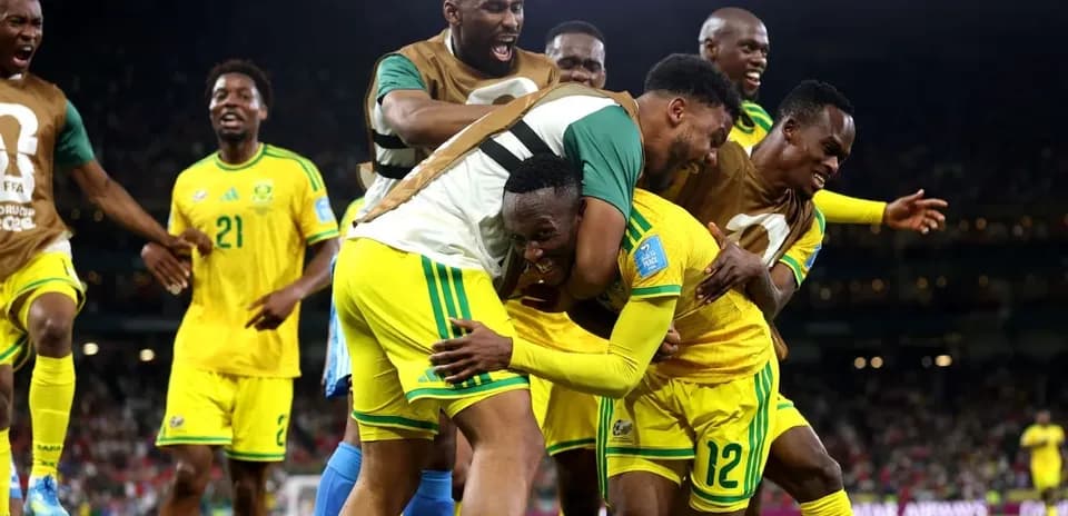 Players celebrating after scoring a goal in match