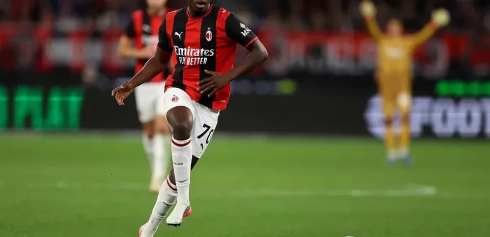 Player running with ball during AC Milan match