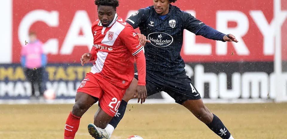 Players competing for the ball in snow