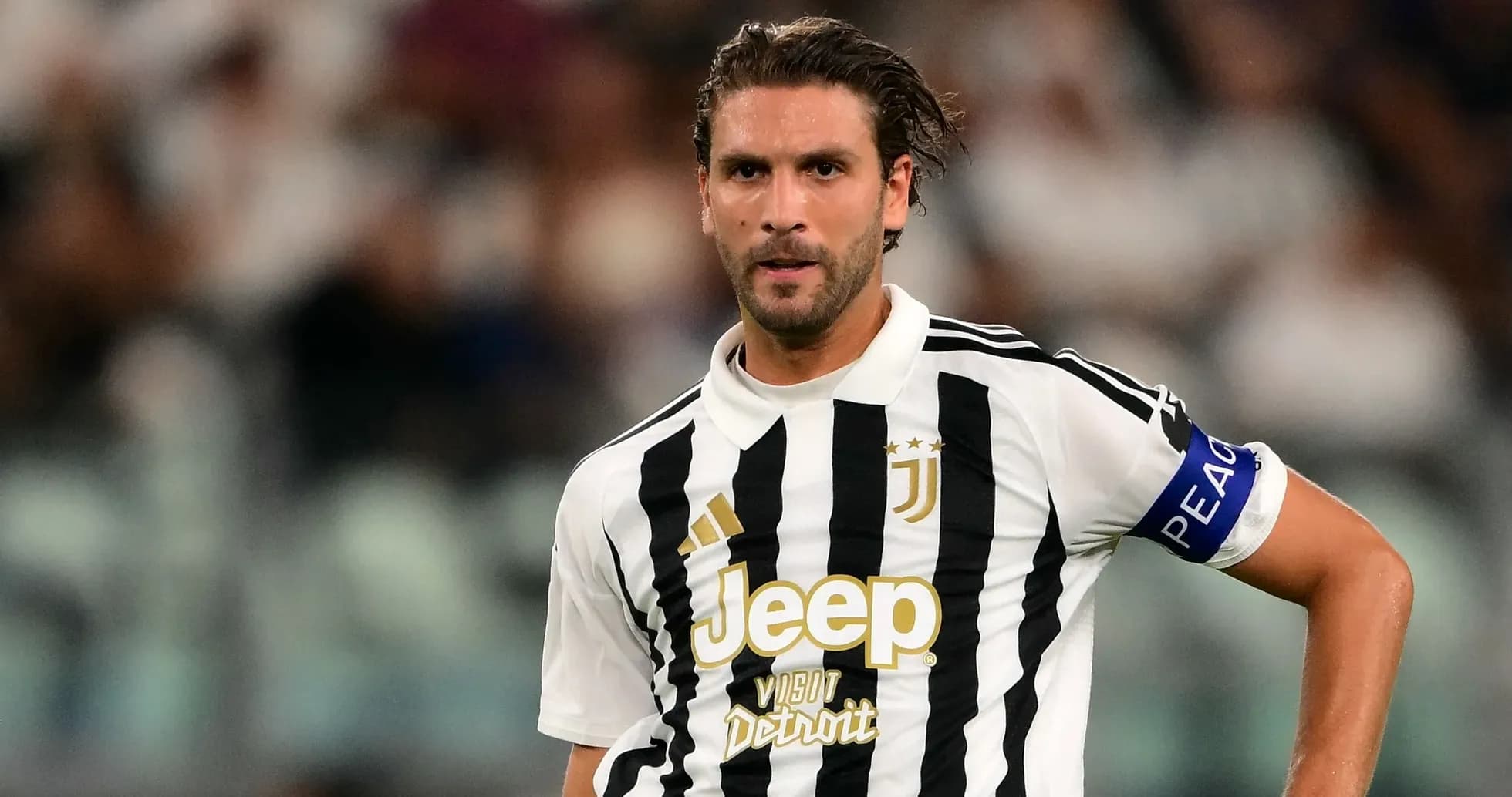 Juventus player in black and white striped jersey