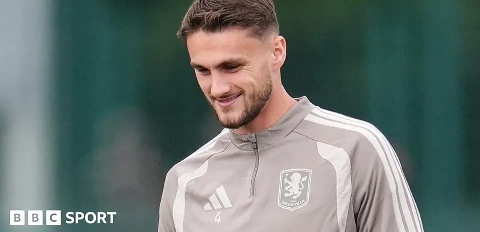 Player in Aston Villa training kit smiling outdoors